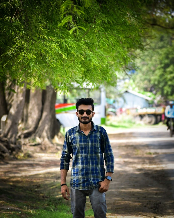 A man standing in the middle of a dirt road